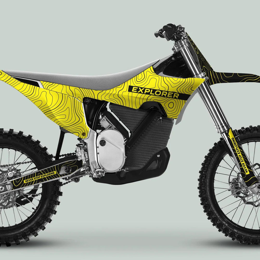 Stark Varg Graphics Kit EXPLORER YELLOW BLACK on a dirt bike, showcasing topographic graphics and Never Stop Exploring slogan, fitted on the body panels.