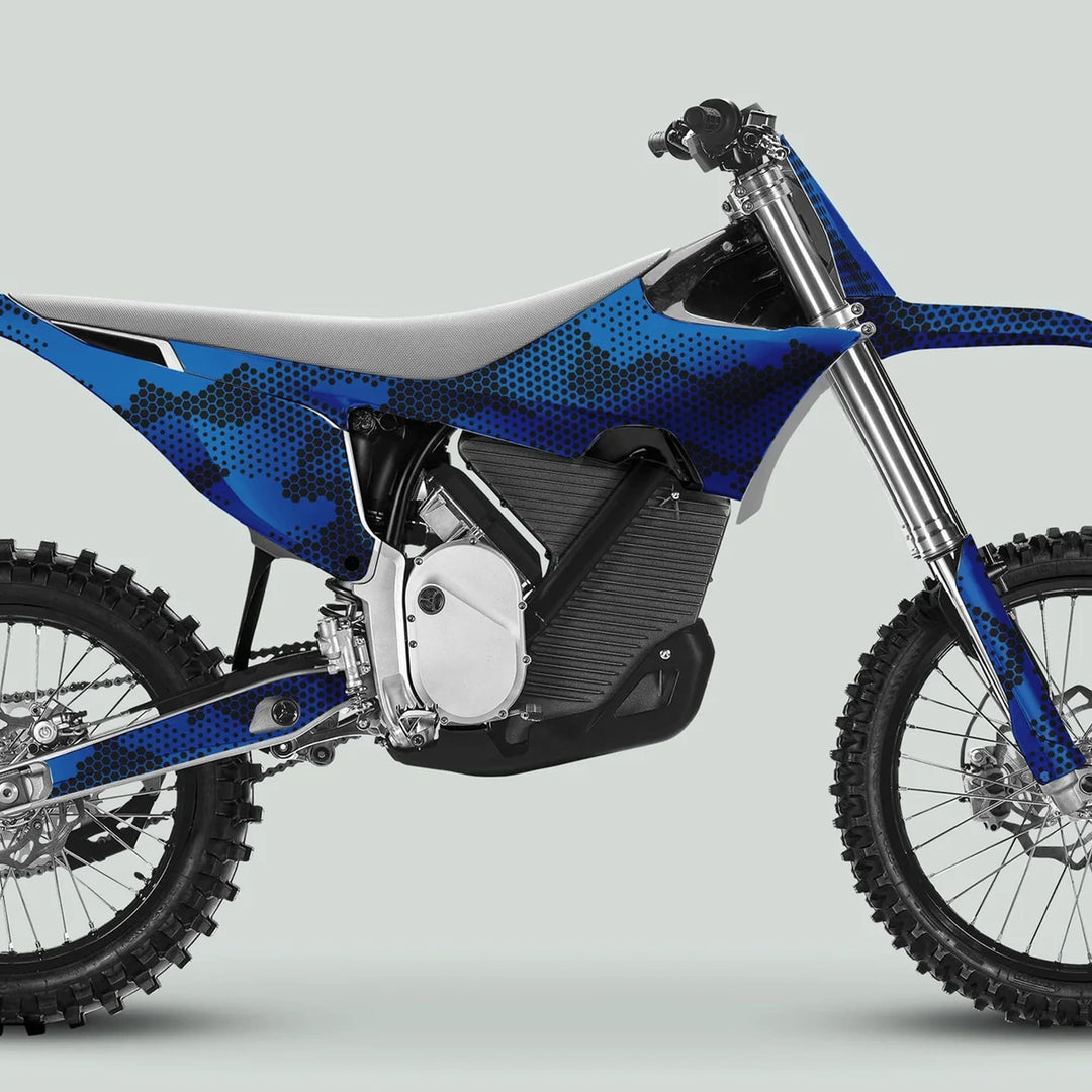 Side-profile of a motocross bike featuring Stark Varg Graphics Kit HEXOCAM BLUE, showcasing blue-and-black camo decals on plastics, enhancing style and durability.