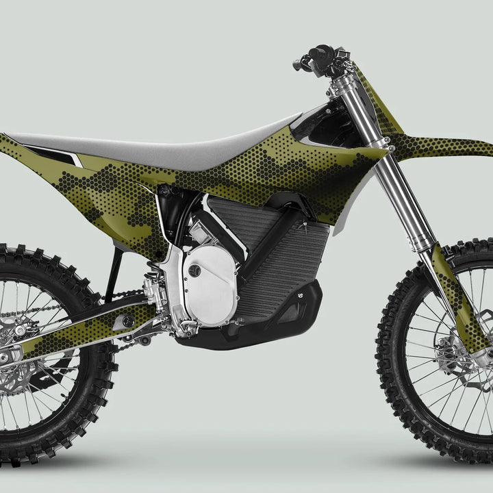 Side-on view of a motocross dirt bike with HEXOCAM Olive decals, showcasing its electric motor, knobby tires, and sporty handlebars.