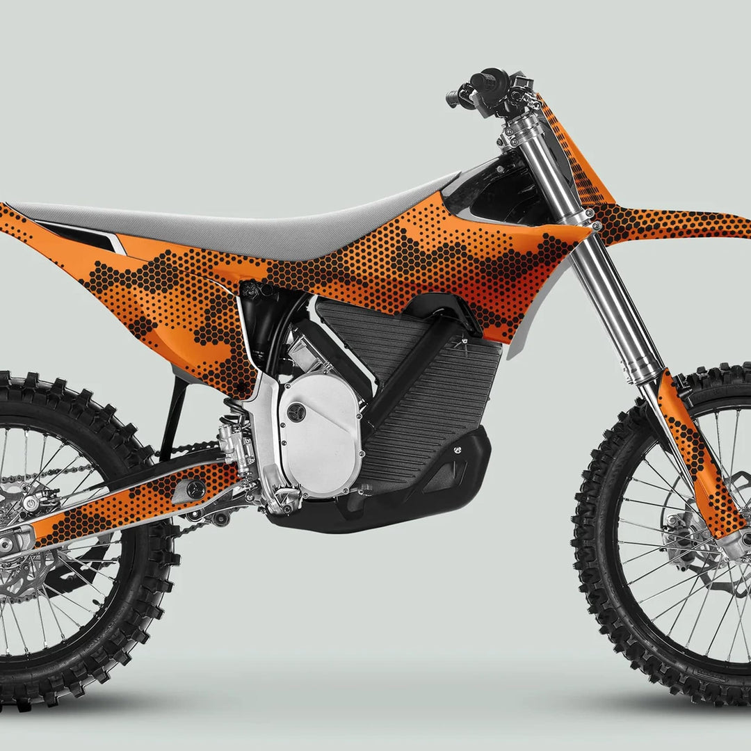 Side profile of an off-road bike with Stark Varg Graphics Kit HEXOCAM Orange Decals, featuring knobby tires and exposed suspension forks, highlighting durability and style.
