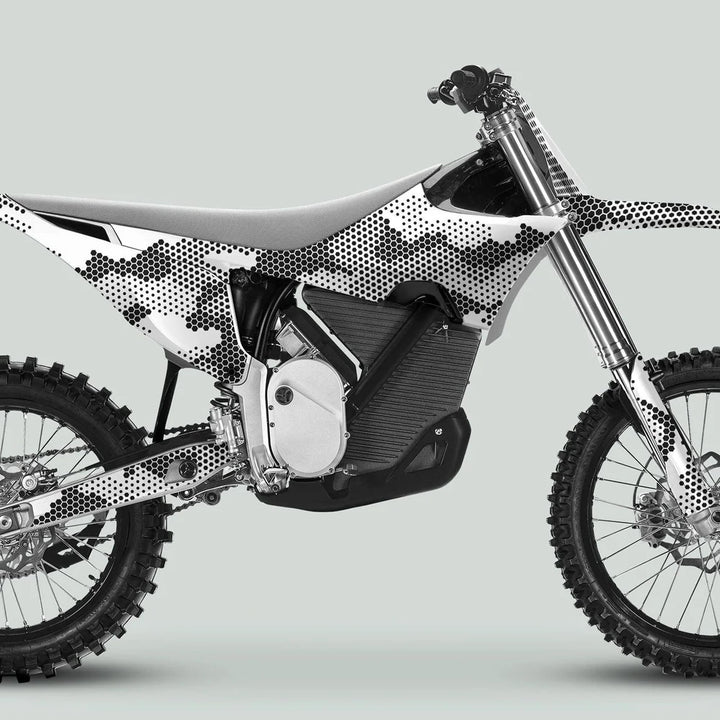 Side-view of a dirt bike featuring Stark Varg Graphics Kit HEXOCAM White Decals, showcasing a camo dot pattern on the electric power-unit area.
