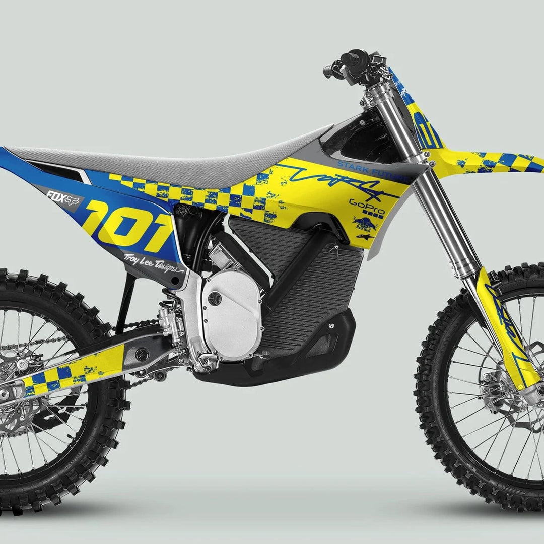 Side-profile of an off-road electric dirt bike featuring the Stark Varg Graphics Kit RACE BLUE Yellow Decals Stickers with sponsor logos on a motocross-style body.