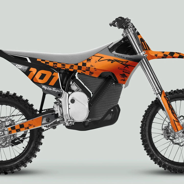 Side profile of a Stark Varg electric dirt bike featuring the RACE BLACK Orange Decals Kit with bold graphics, enhancing its sleek, sporty design.
