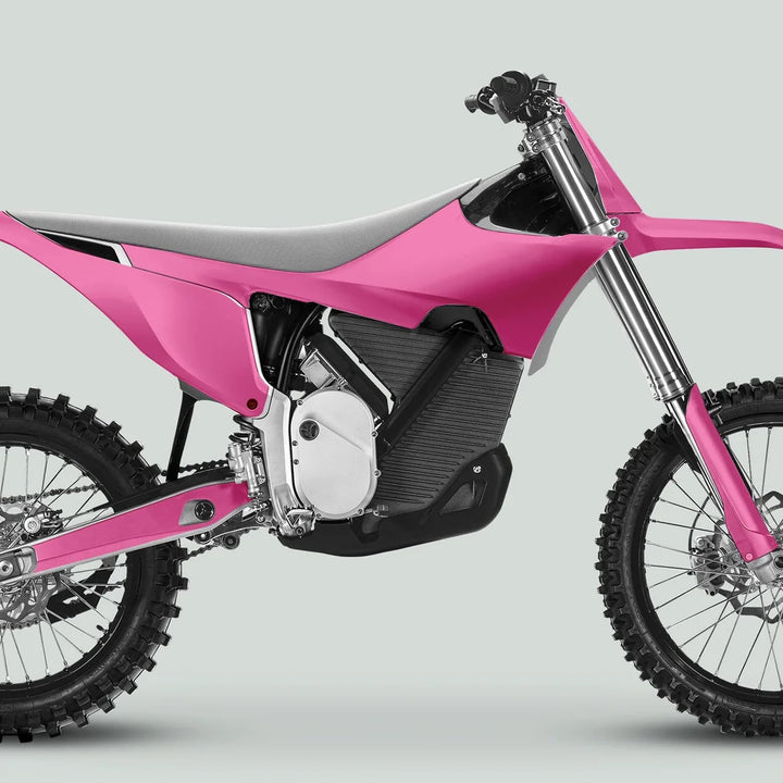 Side-view of Stark Varg with SOLID COLOR PINK Stickers, featuring knobby tires, long-travel forks, and sleek motocross-style bodywork.