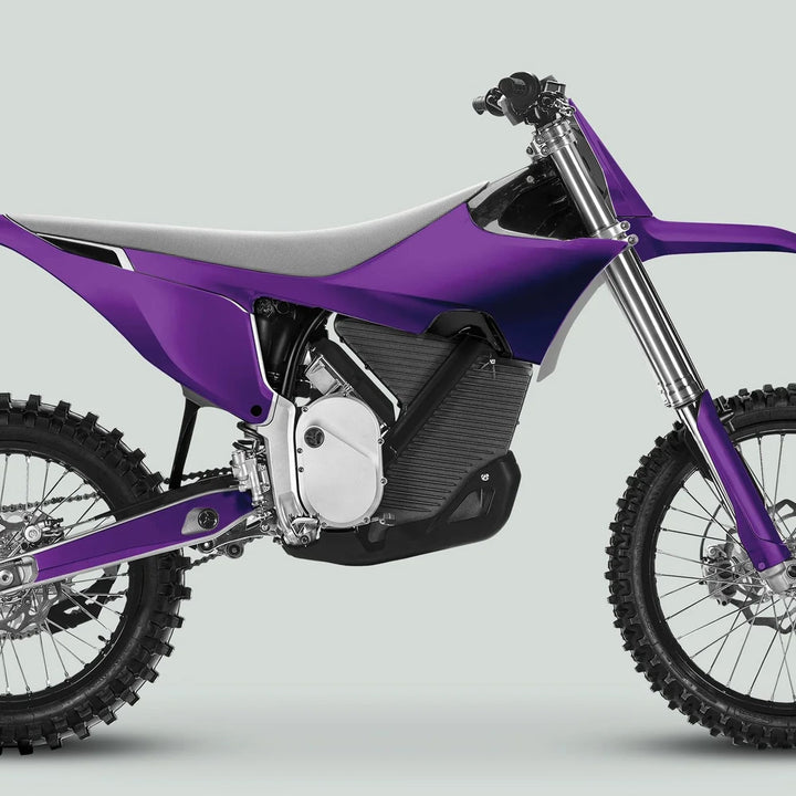 Side profile of Stark Varg Graphics Kit SOLID COLOR PURPLE Stickers on an electric motocross bike, highlighting knobby tires and purple plastics.