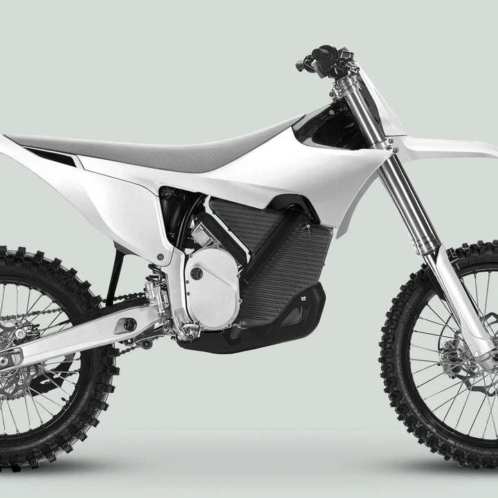 Modern electric dirt bike showcasing Stark Varg Graphics Kit SOLID COLOR WHITE Stickers, featuring comprehensive coverage with glossy, durable finish for stylish enhancement.