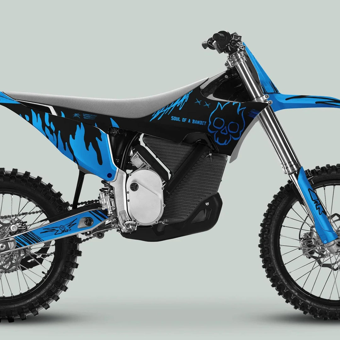 Side view of a blue-and-black Stark Varg dirt bike featuring the SOUL FLAME Black Cyan Decals with flame graphics and skull motif, highlighting customization potential.