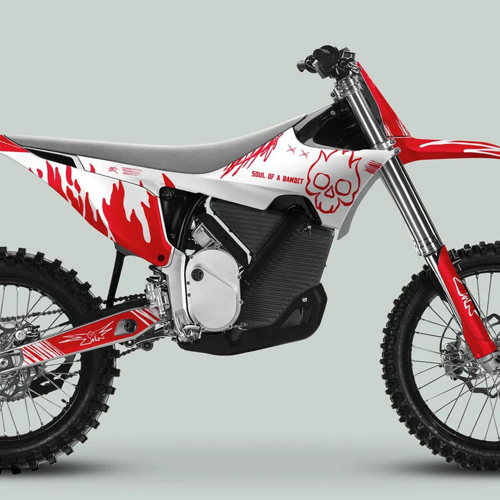 Side-profile of a dirt bike featuring the Stark Varg Graphics Kit SOUL FLAME White Red Decals Stickers with flame graphics and skull emblem.
