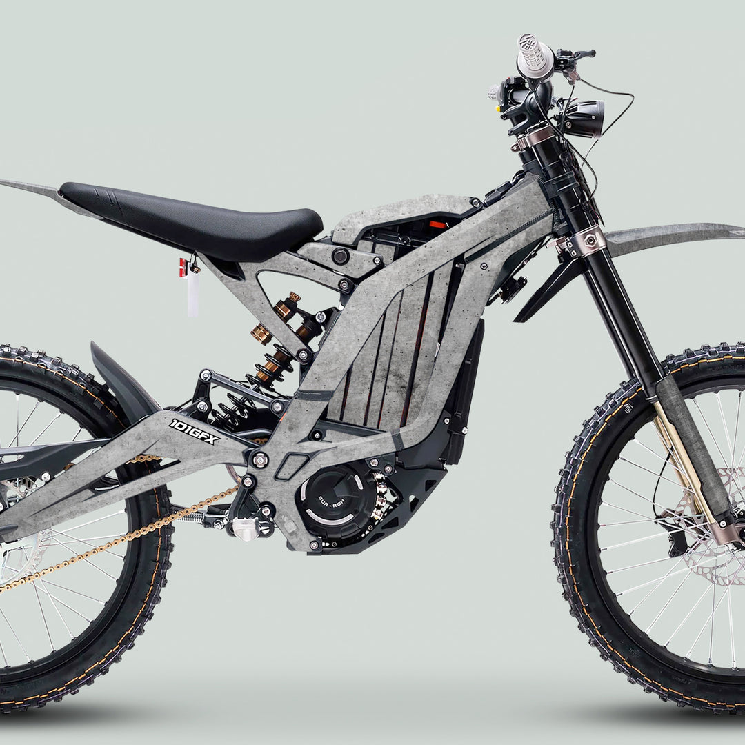 Surron Light Bee X Graphics Kit CONCRETE Grey on an electric off-road bike, featuring durable decals enhancing the bike’s sleek frame and rugged components.