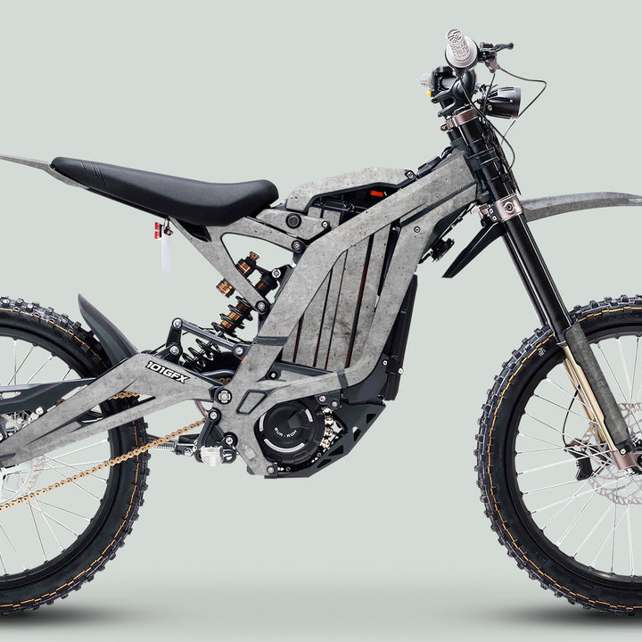 Surron Light Bee X Graphics Kit CONCRETE Grey on an electric off-road bike, featuring durable decals enhancing the bike’s sleek frame and rugged components.