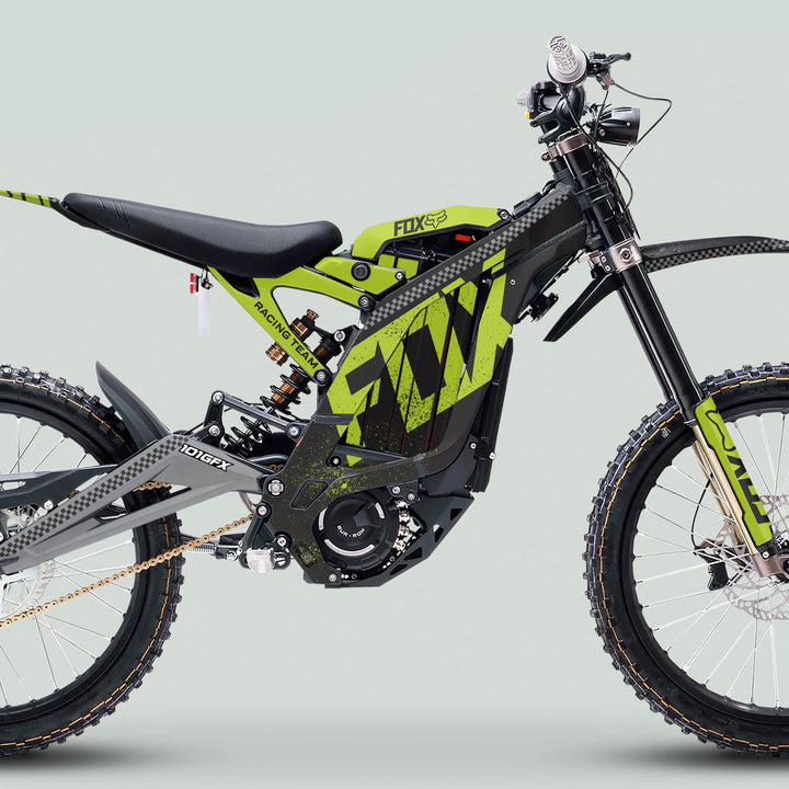 Surron Light Bee X Graphics Kit FOX DUST Black Green on an electric dirt bike, showcasing a modern design with durable decals, FOX-branded suspension, and knobby tires.