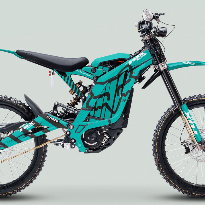 Side profile of Surron Light Bee X Graphics Kit FOX RACE LINE Mint Black on an electric dirt bike, showcasing its full-suspension design and race-inspired graphics.