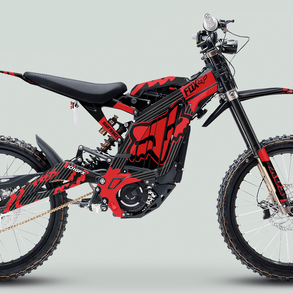 Red-and-black electric dirt bike featuring Surron Light Bee X Graphics Kit FOX STRIPES BLACK Red with knobby tires, suspension, and FOX branding for a motocross aesthetic.