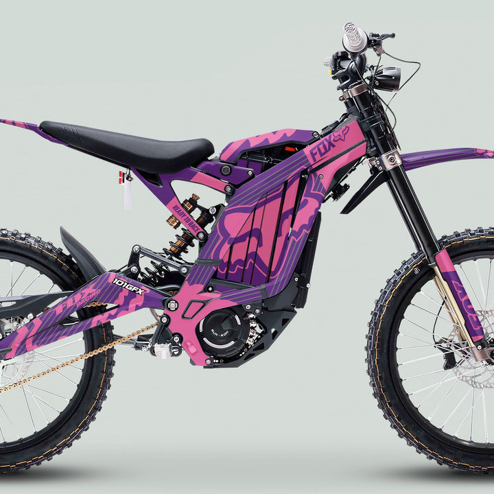 Surron Light Bee X Graphics Kit FOX STRIPES PURPLE Pink on a full-suspension electric dirt bike, featuring rugged components and vibrant, durable graphics for enhanced style and performance.