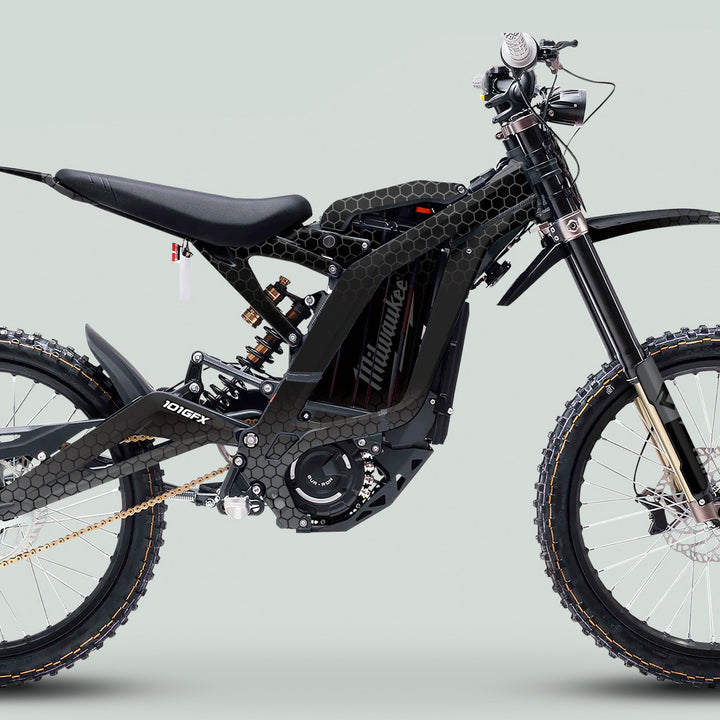 Surron Light Bee X Graphics Kit HONEYCOMB Black Grey on electric off-road bike with full-suspension, knobby tires, gold chain, and integrated battery-motor.