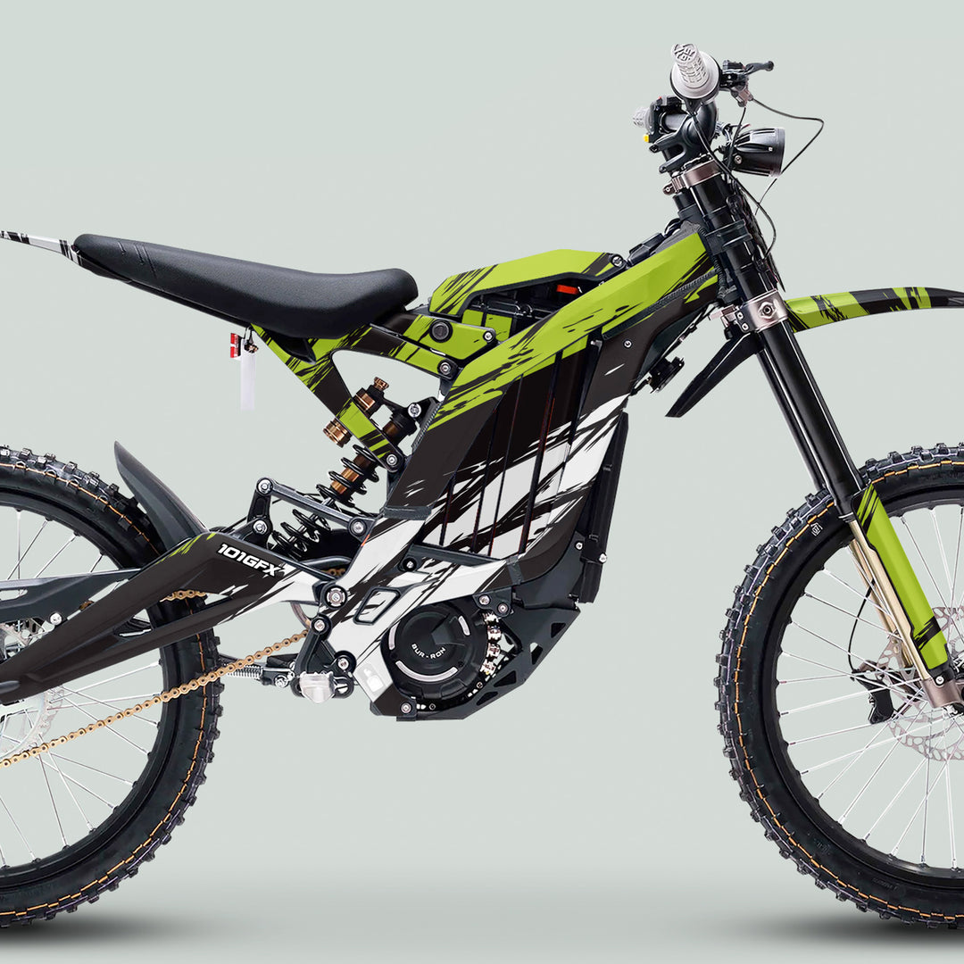 Surron Light Bee X Graphics Kit SLICE BLACK Green on an electric dirt bike with knobby wheels, inverted forks, monoshock, and gold chain drive.