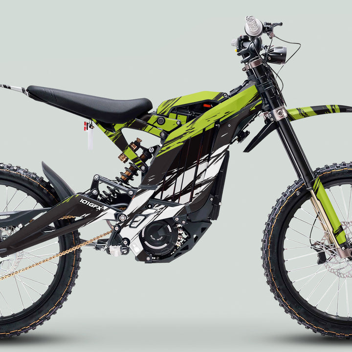 Surron Light Bee X Graphics Kit SLICE BLACK Green on an electric dirt bike with knobby wheels, inverted forks, monoshock, and gold chain drive.