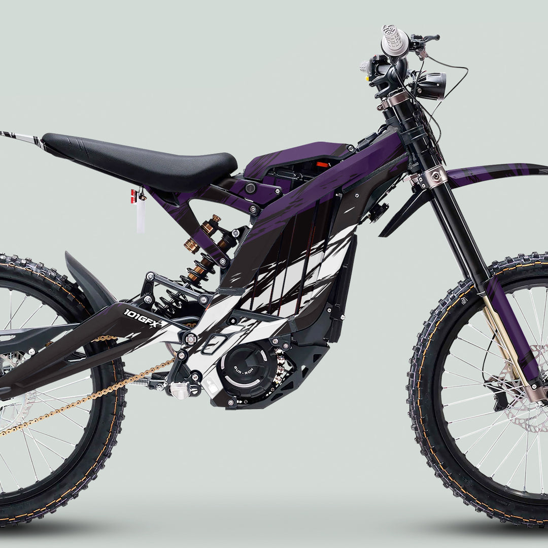 Surron Light Bee X Graphics Kit SLICE BLACK Purple displayed on an e-dirt bike, highlighting glossy laminated stickers and a perfect fit for enhanced style and protection.