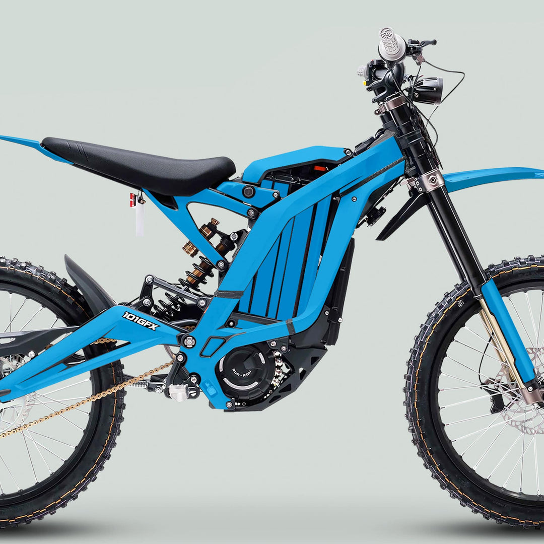 Surron Light Bee X Graphics Kit MONO COLOR Cyan shown on a blue electric dirt bike, highlighting the vibrant cyan design enhancing the bike's frame and components.