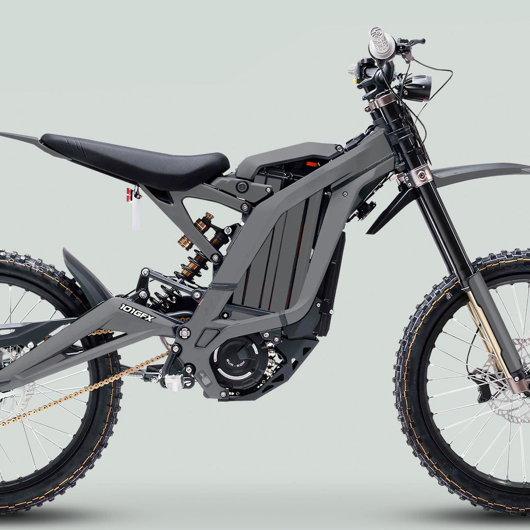 Surron Light Bee X Graphics Kit MONO COLOR Grey on an electric dirt bike featuring large knobby tires, exposed frame, and central battery, enhancing style and protection.