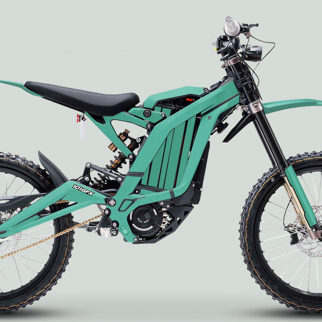 Surron Light Bee X Graphics Kit MONO COLOR Mint on an electric dirt-bike with tubular frame, knobby tires, long-travel suspension, and disc brakes, enhancing appearance and protection.