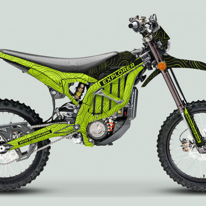 Surron Ultra Bee Graphics Kit EXPLORER GREEN BLACK on enduro bike, features topographic contour design, NEVER STOP EXPLORING slogan, knobby tires, electric motor.