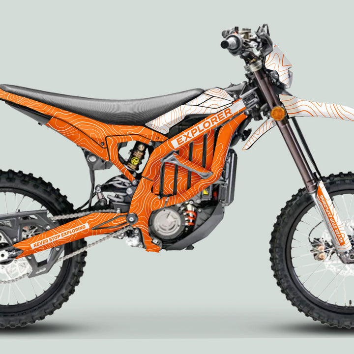 Surron Ultra Bee Graphics Kit EXPLORER ORANGE WHITE on a motorcycle with contour-line patterns, EXPLORER branding, knobby tires, high-clearance frame, and long-travel suspension.