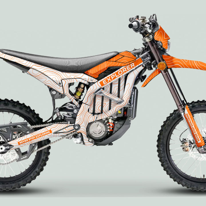 Surron Ultra Bee Graphics Kit EXPLORER WHITE ORANGE on a dirt bike, showcasing orange-and-white topographic pattern and EXPLORER decal on the fuel tank.
