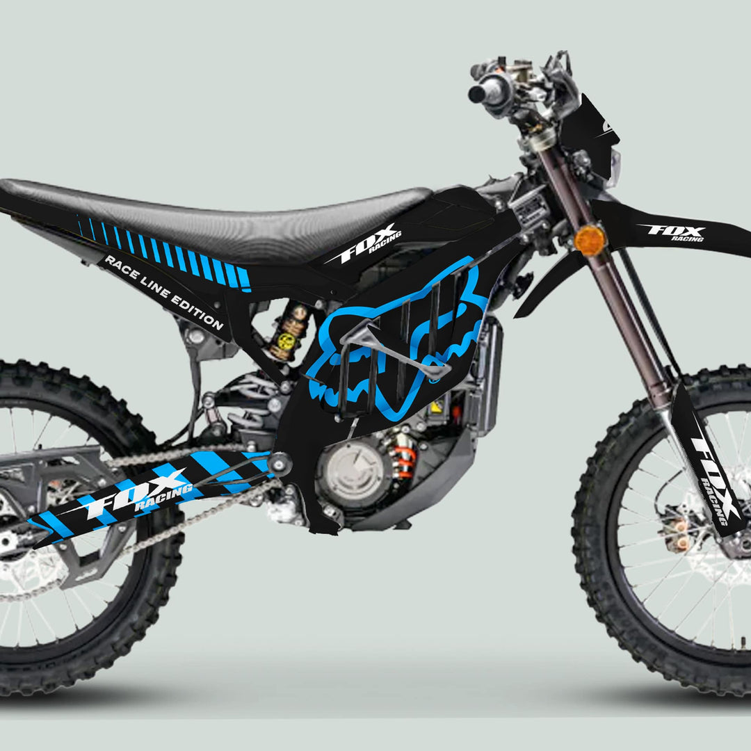 Surron Ultra Bee Graphics Kit FOX RACE LINE Black Cyan on motocross bike, featuring knobby tires and long-travel forks, showcasing durable, stylish decals.
