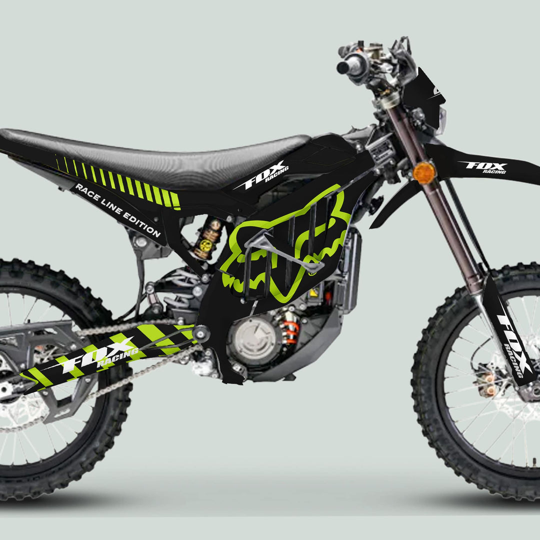 Surron Ultra Bee Graphics Kit FOX RACE LINE Black Green on dirt bike, featuring Fox Racing logos, knobby tires, and padded seat, enhancing style and protection.