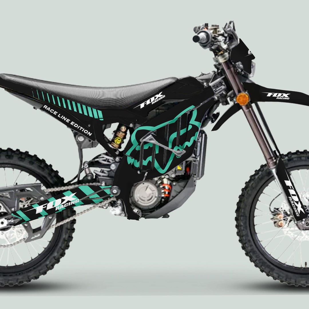 Surron Ultra Bee Graphics Kit FOX RACE LINE Black Mint on dirt bike, featuring black plastics with mint-green Fox logos, showcasing knobby tires and suspension components.