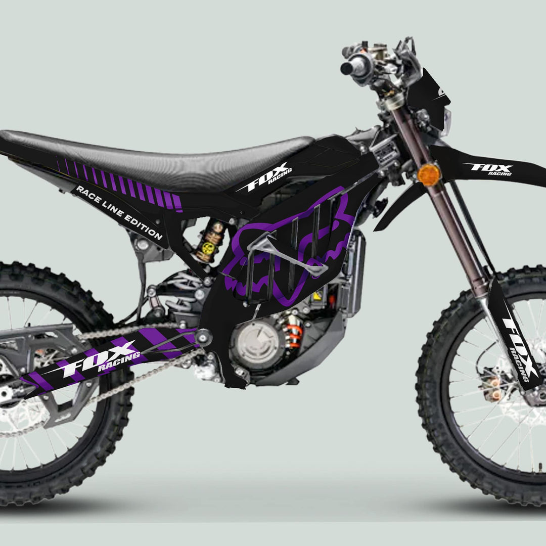 Surron Ultra Bee Graphics Kit FOX RACE LINE Black Purple on black off-road motorcycle, featuring knobby tires, exposed engine, and purple graphics for enhanced aesthetic and durability.