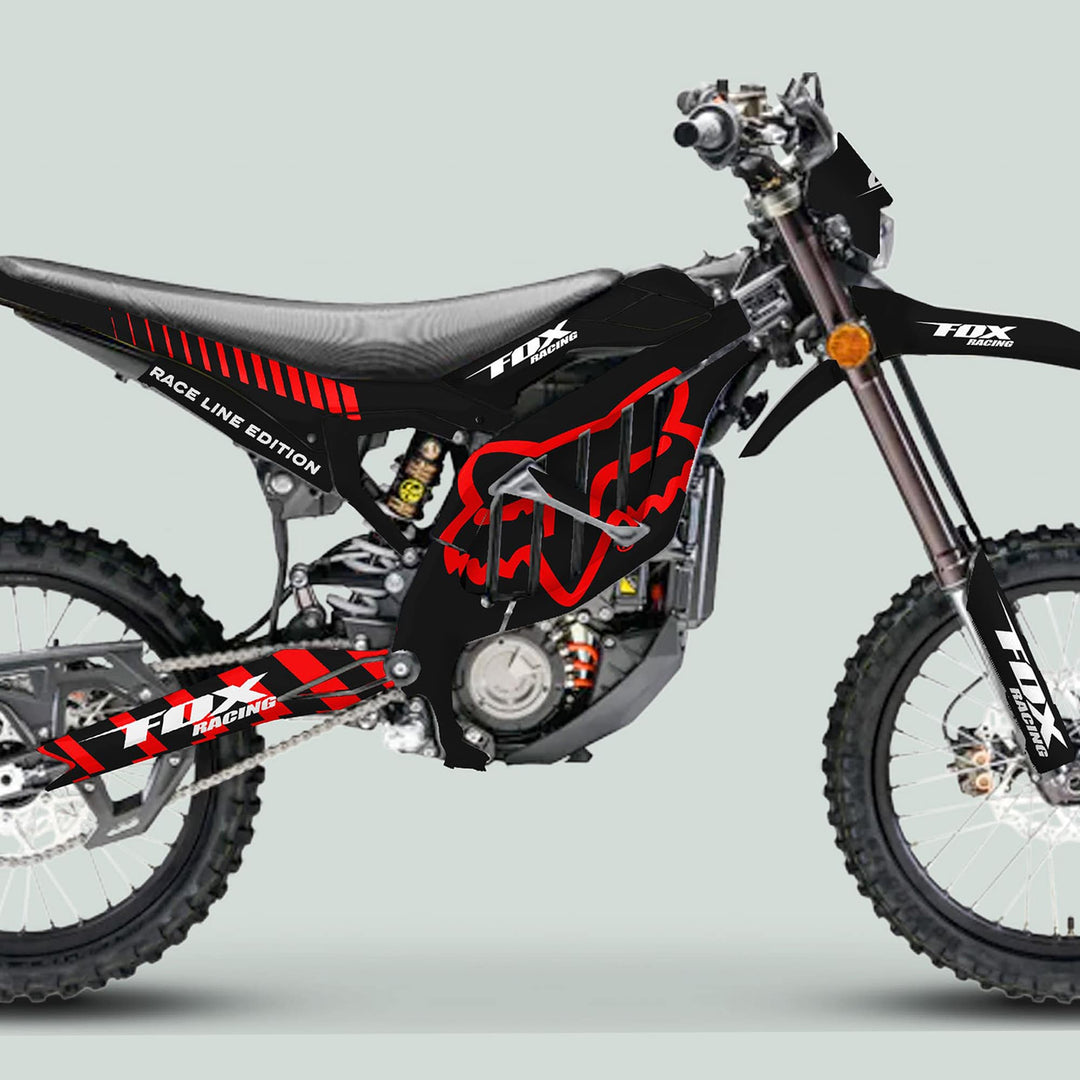Surron Ultra Bee Graphics Kit FOX RACE LINE Black Red on a motocross bike, showcasing its knobby tires, front suspension, engine, and sleek seat.