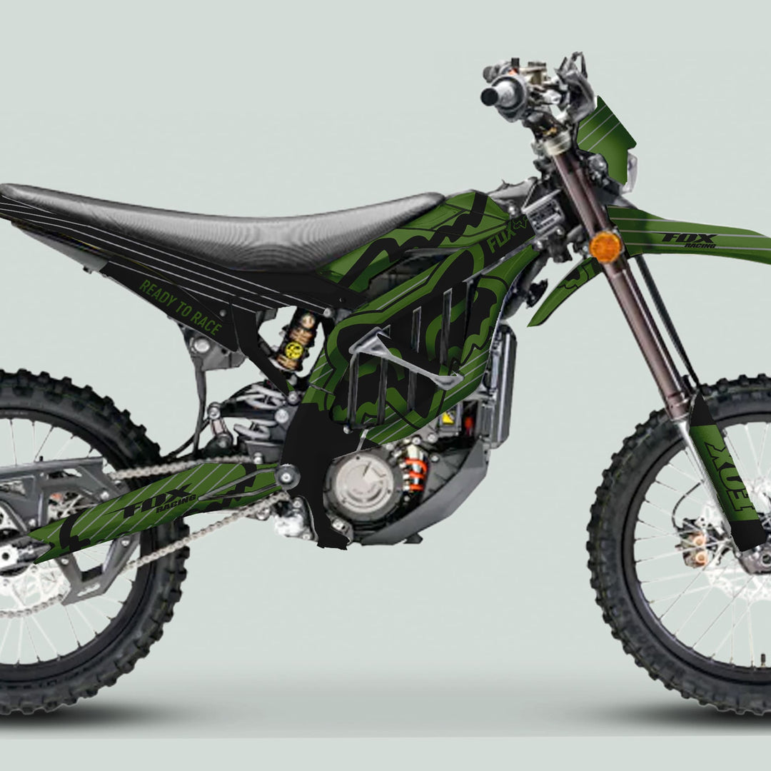 Surron Ultra Bee Graphics Kit FOX STRIPES Moss Black on motocross bike with knobby tires, long-travel suspension, and Fox Racing livery, enhancing style and durability.