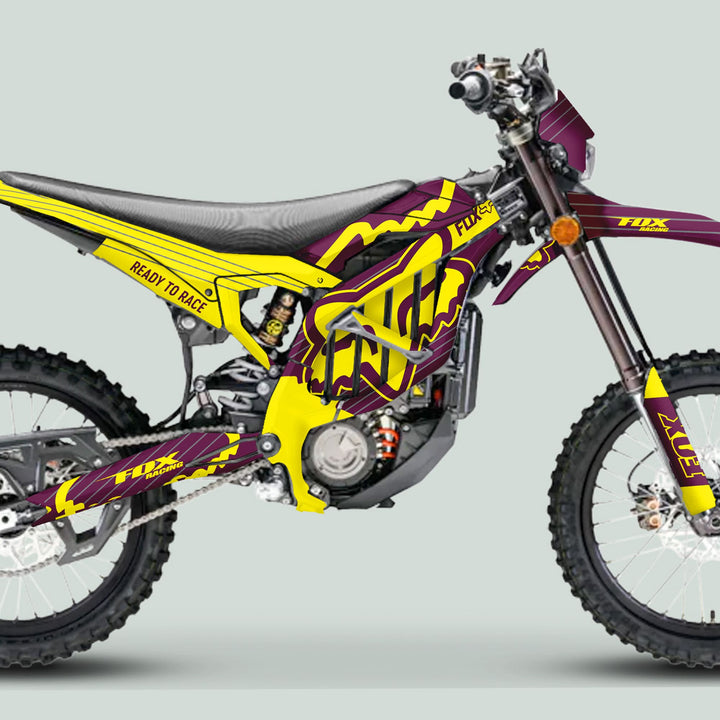 Surron Ultra Bee Graphics Kit FOX STRIPES enhances a dirt bike with robust purple-yellow Fox designs, showcasing race-ready style and durable vinyl quality.