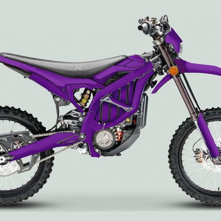 Side view of a purple electric dirt bike featuring the Surron Ultra Bee Graphics Kit SOLID COLOR PURPLE, showcasing knobby tires, tubular frame, and sleek design.