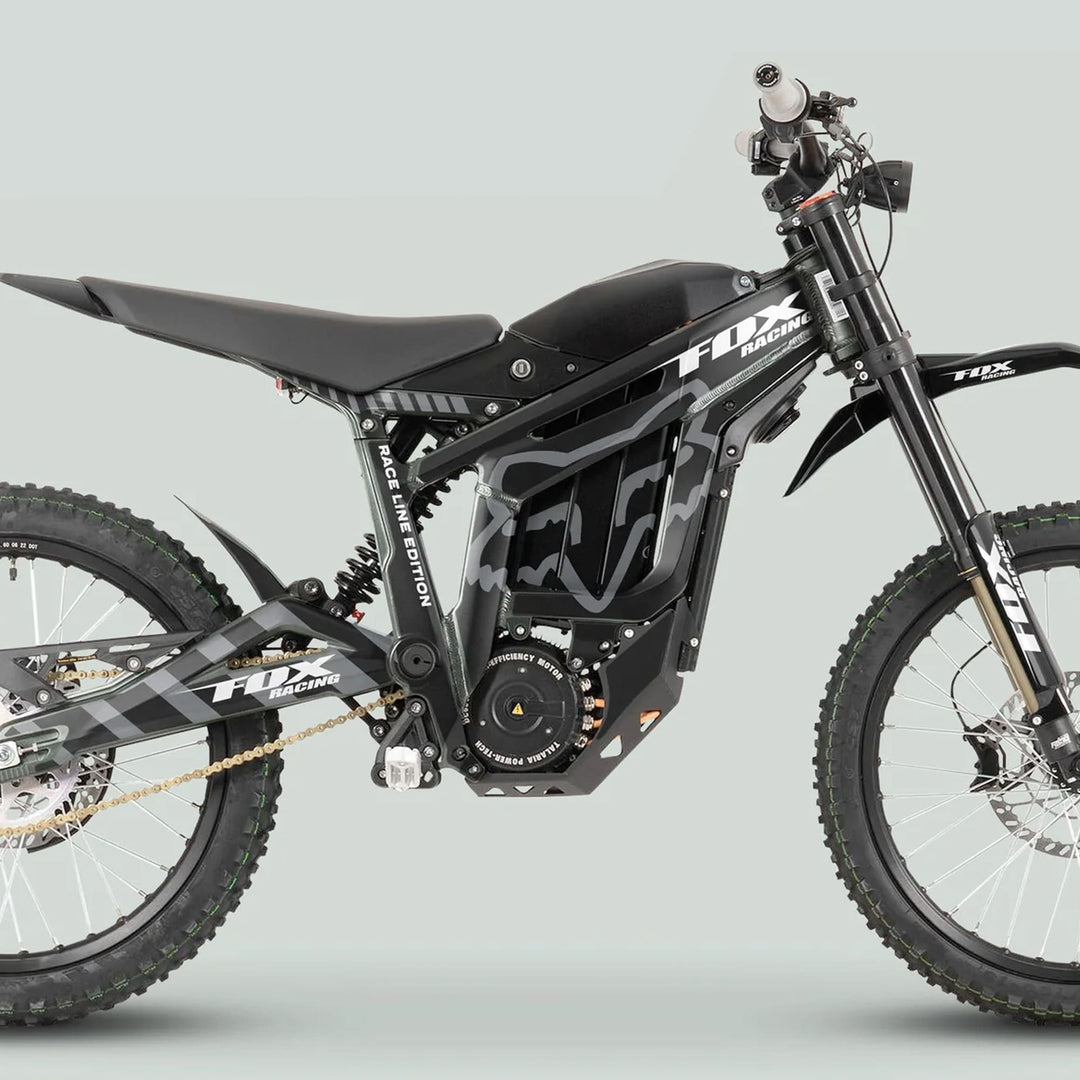 Talaria Sting MX3 MX4 Graphics Kit on black electric off-road bike with FOX Racing graphics, featuring long-travel forks, knobby tires, and a gold chain drive.