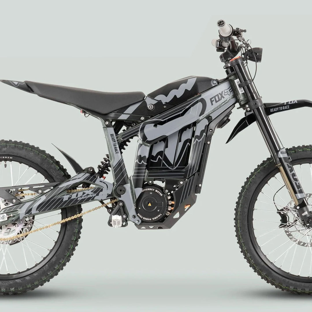 Talaria Sting MX3 MX4 Graphics Kit FOX STRIPES Black Grey on a full-suspension electric dirt bike with robust frame, knobby tires, and distinctive motocross features.