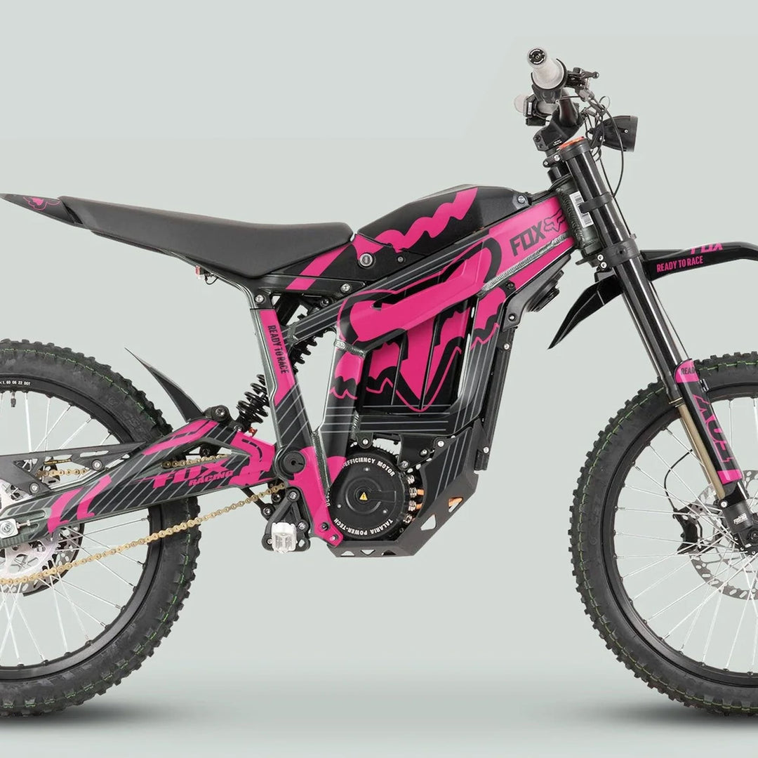 Pink-and-black Talaria Sting MX3 MX4 Graphics Kit FOX STRIPES Black Magenta on an electric off-road motorcycle, featuring full suspension and knobby tires.