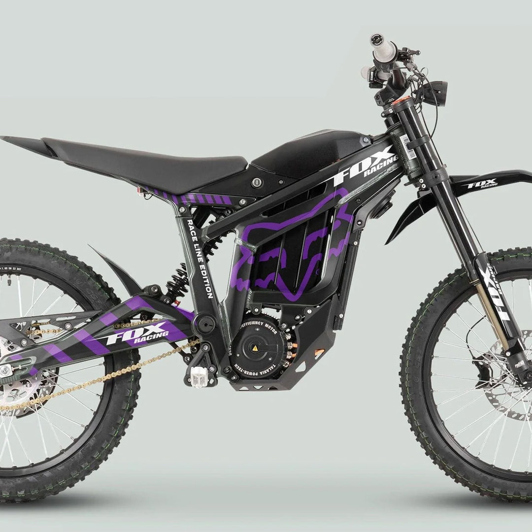Talaria Sting MX3 MX4 Graphics Kit FOX Raceline Black Purple on an off-road electric dirt bike with tubular frame and knobby tires.