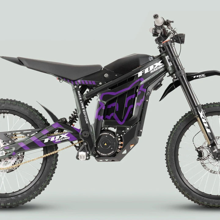 Talaria Sting MX3 MX4 Graphics Kit FOX Raceline Black Purple on an off-road electric dirt bike with tubular frame and knobby tires.
