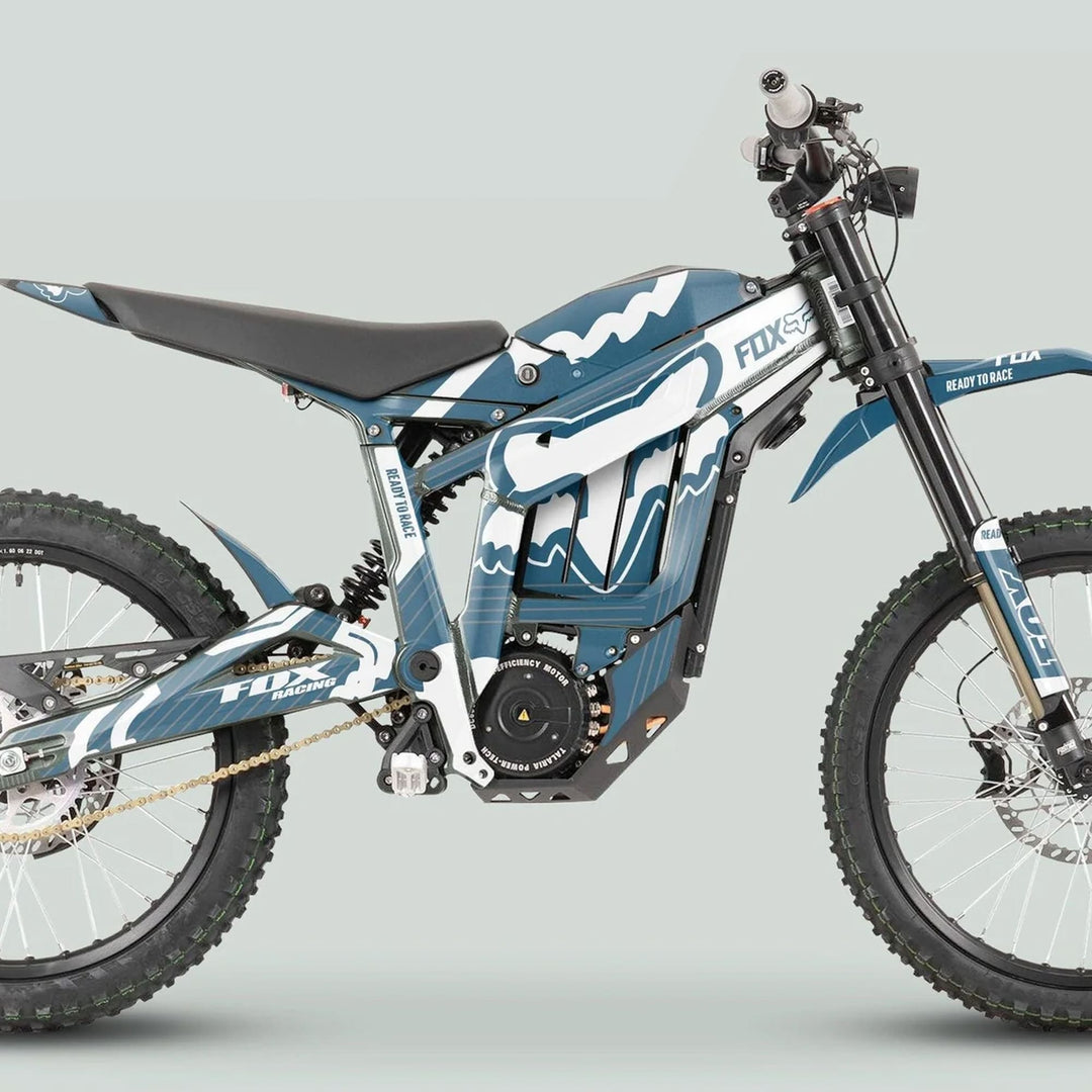 Side-view of Talaria Sting MX3 MX4 Graphics Kit FOX STRIPES Grey White on an electric off-road motorcycle with FOX livery, featuring durable decals and knobby tires.