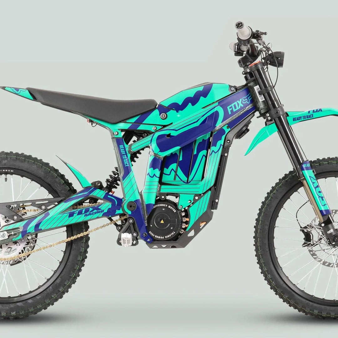 Talaria Sting MX3 MX4 Graphics Kit FOX STRIPES Mint Navy on an electric dirt bike with teal-blue wrap, long-travel forks, and knobby tires.