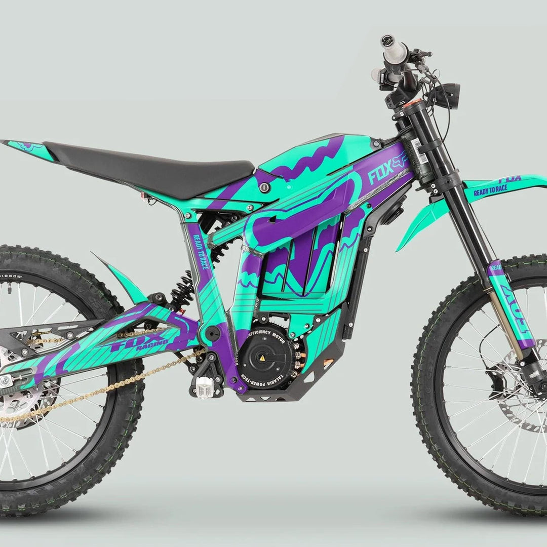 Side-view of a Talaria Sting MX3 MX4 Graphics Kit FOX STRIPES Mint Purple featuring knobby tires and teal-purple livery on an electric off-road motorcycle.