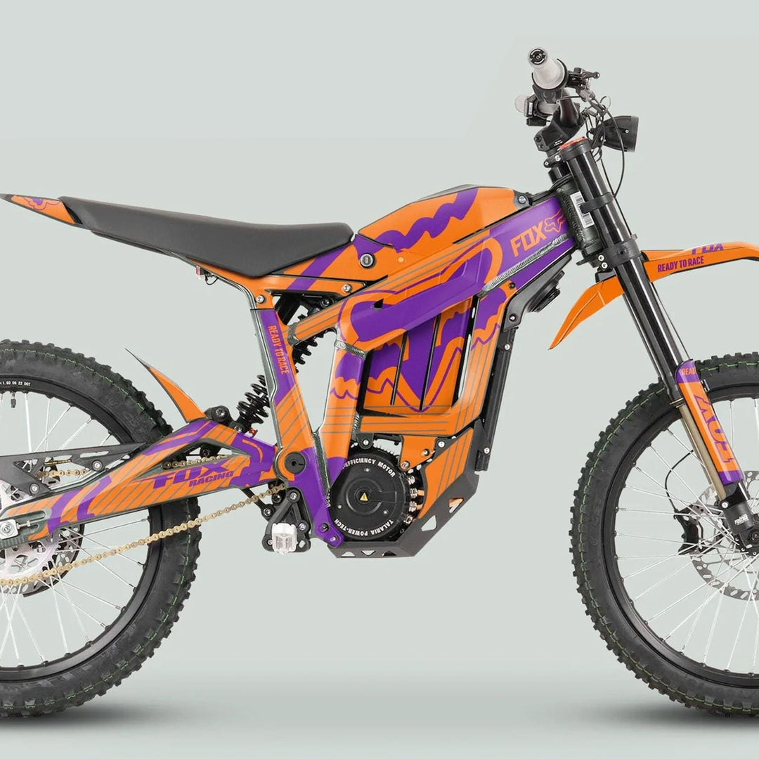 Side-view of Talaria Sting MX3 MX4 Graphics Kit FOX STRIPES Orange Purple, showcasing orange-purple stripes, tubular frame, dual suspension, and centrally-mounted battery on an electric off-road bike.