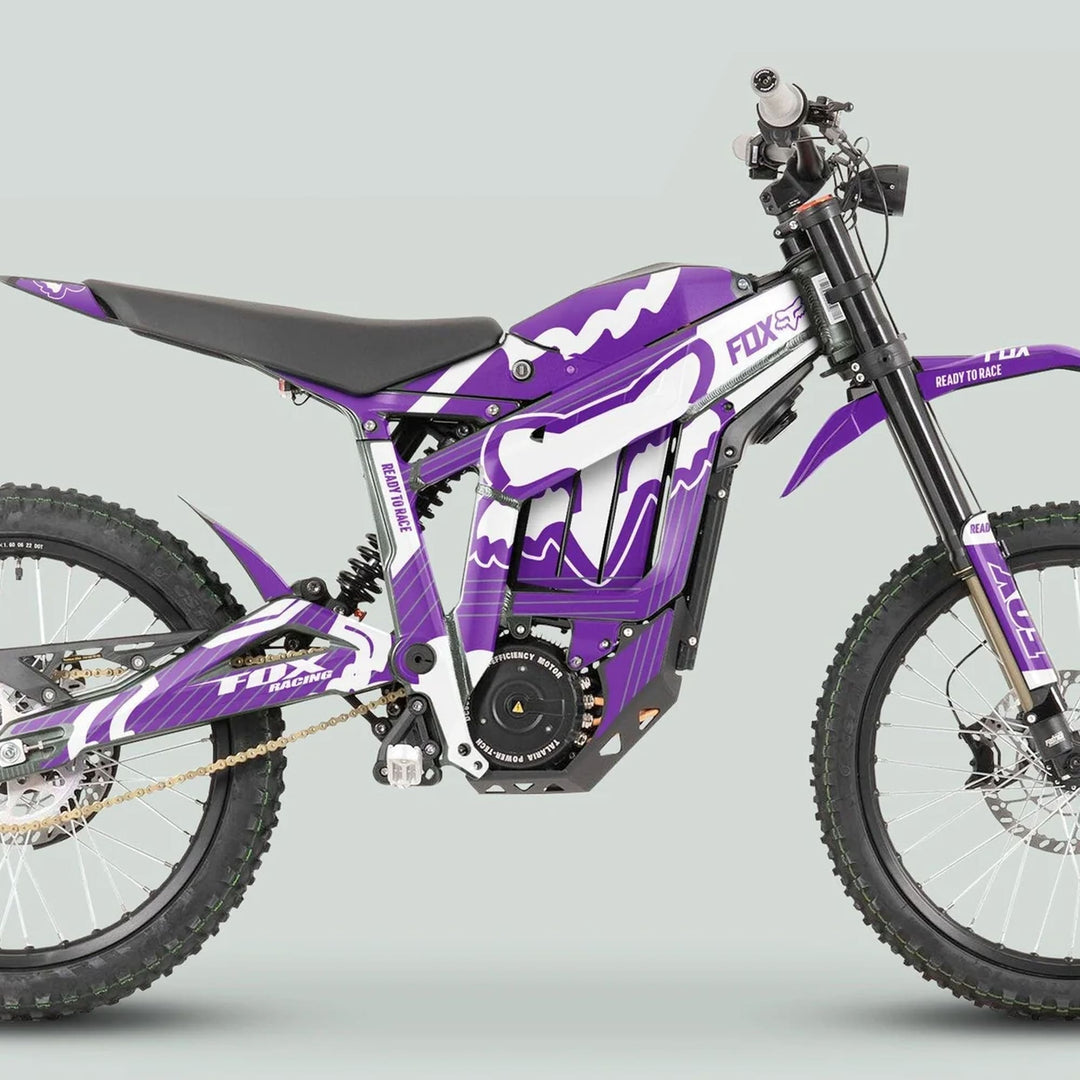 Talaria Sting MX3 MX4 Graphics Kit FOX STRIPES Purple White on a Fox Racing electric dirt bike, featuring vibrant graphics on a tubular frame with knobby tires.