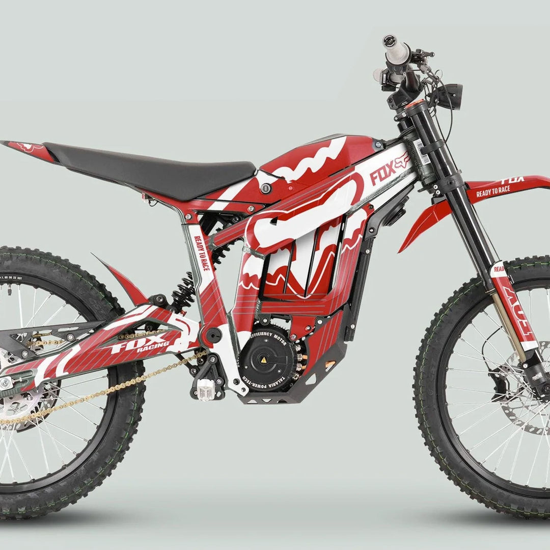 Side view of the Talaria Sting MX3 MX4 Graphics Kit FOX STRIPES Red White on an e-dirt bike, showcasing knobby tires, electric motor, and racing graphics.