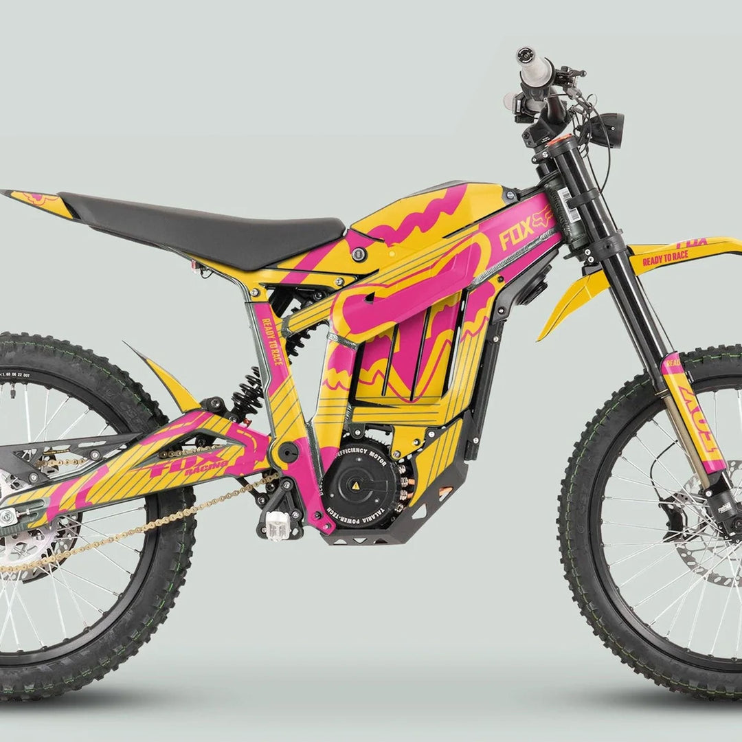 Talaria Sting MX3 MX4 Graphics Kit FOX STRIPES on an electric dirt bike, featuring vibrant yellow and magenta decals, enhancing the sleek, angular frame for off-road adventures.