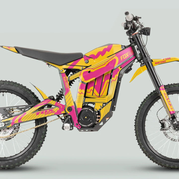 Talaria Sting MX3 MX4 Graphics Kit FOX STRIPES on an electric dirt bike, featuring vibrant yellow and magenta decals, enhancing the sleek, angular frame for off-road adventures.