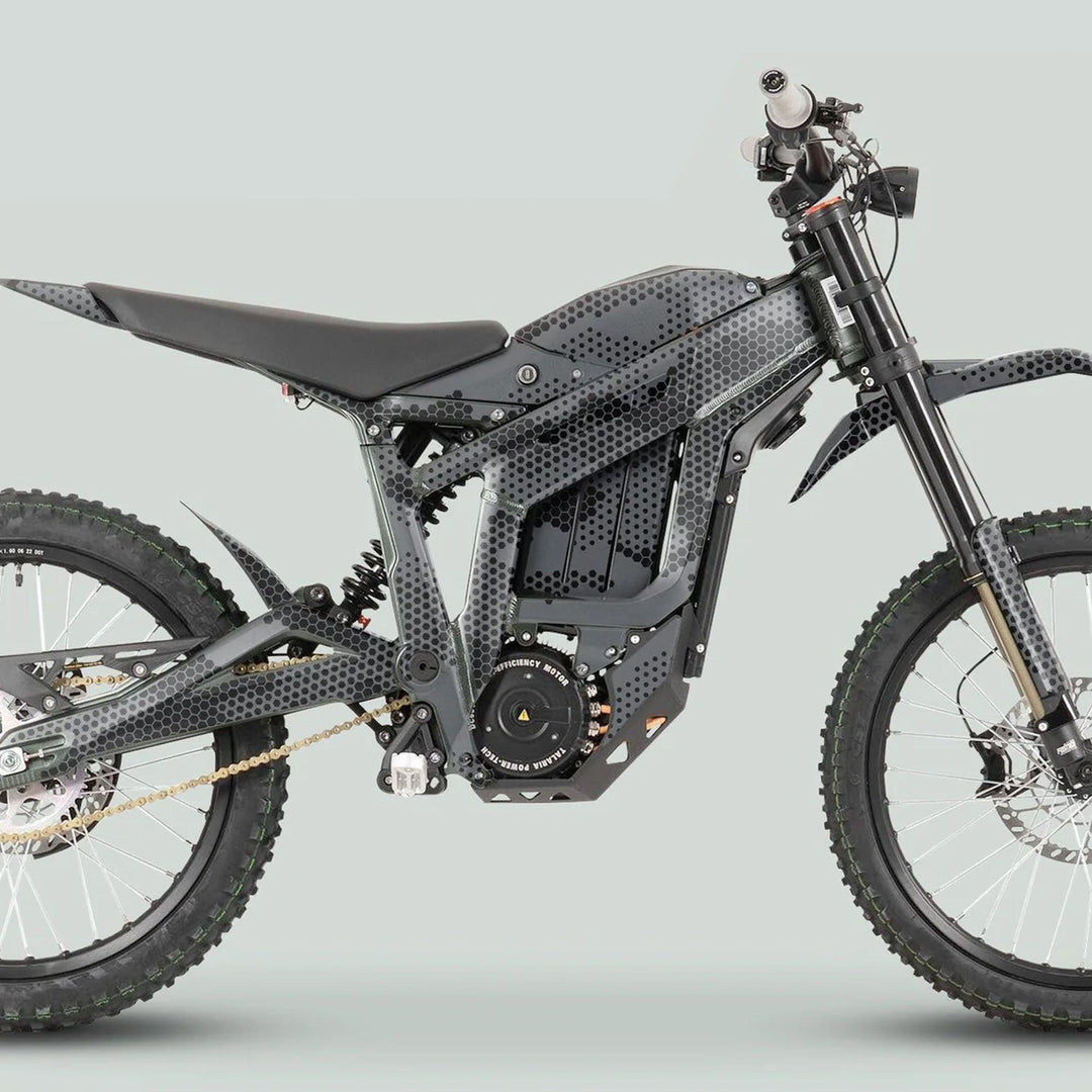 Side-profile of Talaria Sting MX3 MX4 with HEXOCAM Grey Graphics Kit, featuring tubular frame, off-road suspension, and knobby wheels for trail riding.